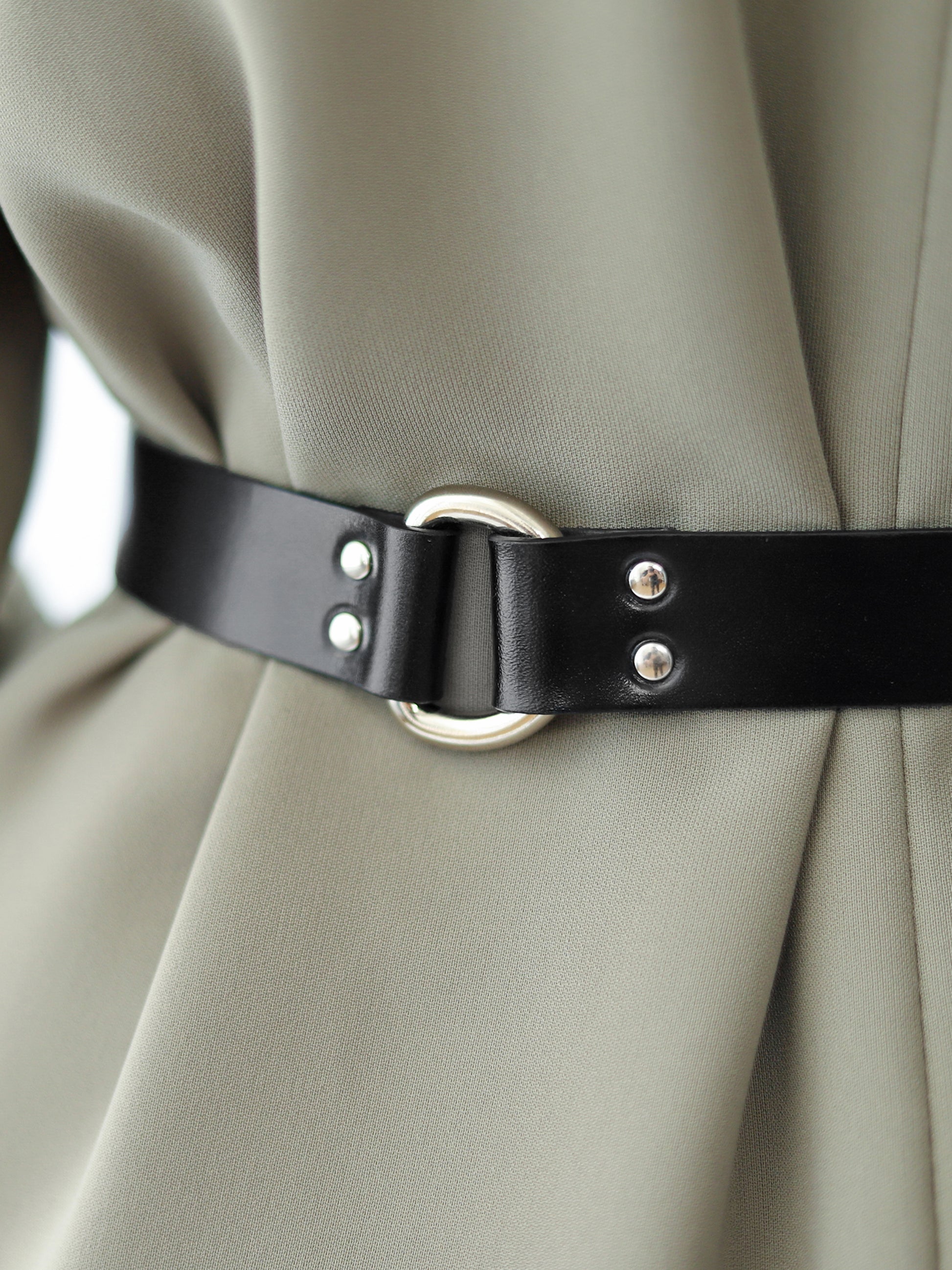 Detailed view of slim leather belt.