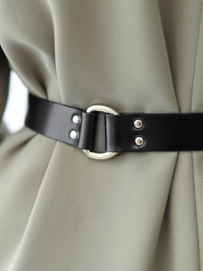 Detailed view of slim leather belt.