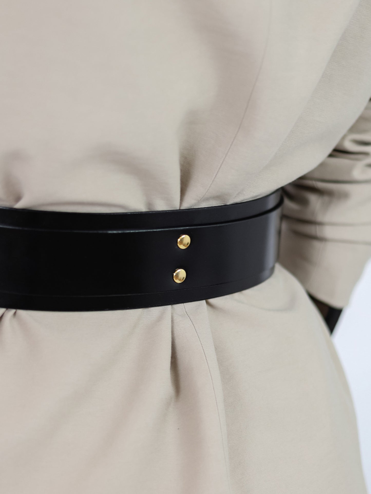 Back detailed view of black leather belt for women.