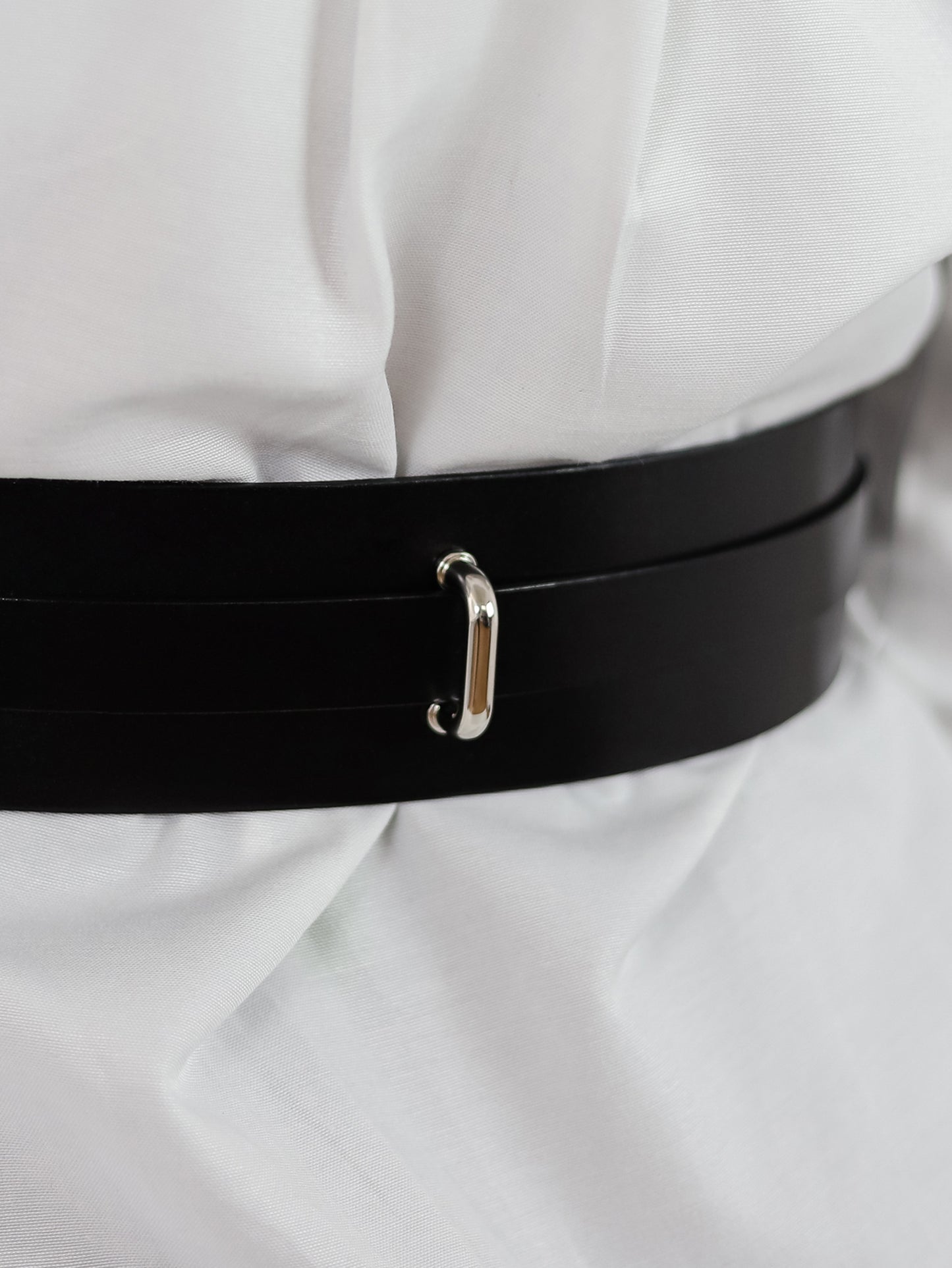 Back details of black leather belt.