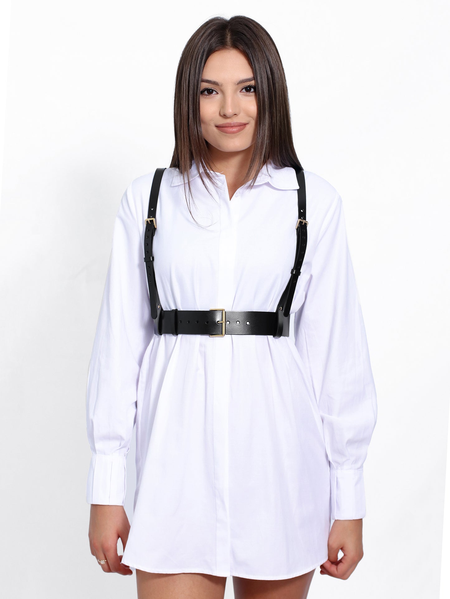 Black leather harness worn with white shirt.
