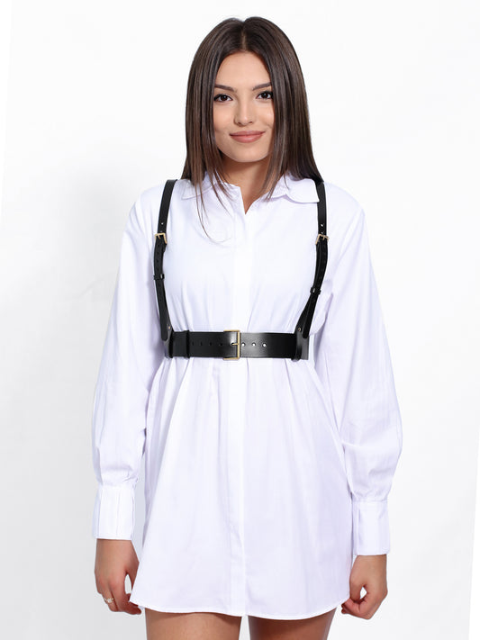 Black leather harness worn with white shirt.