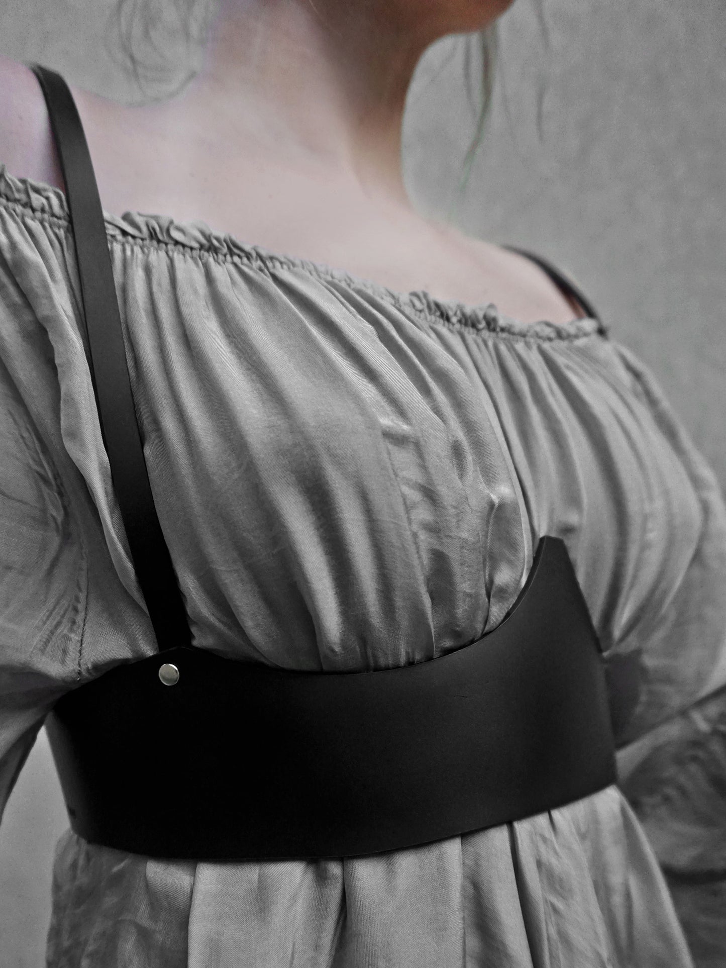 Close view of black underbust harness.