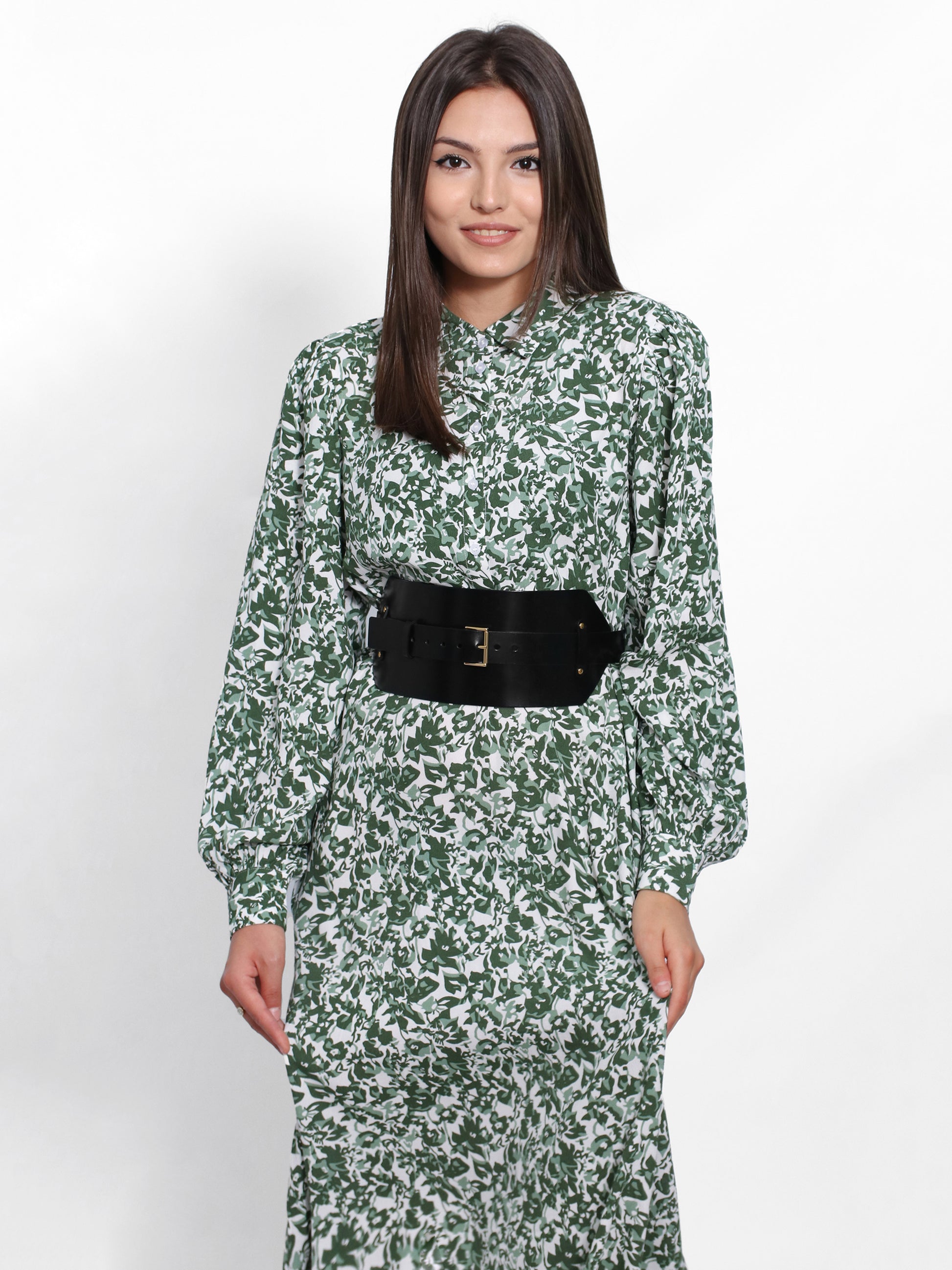 Black leather wide belt worn over green dress.