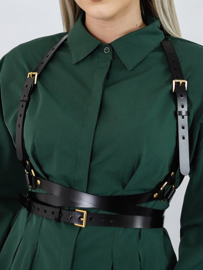 Close view of gold hardware leather harness.