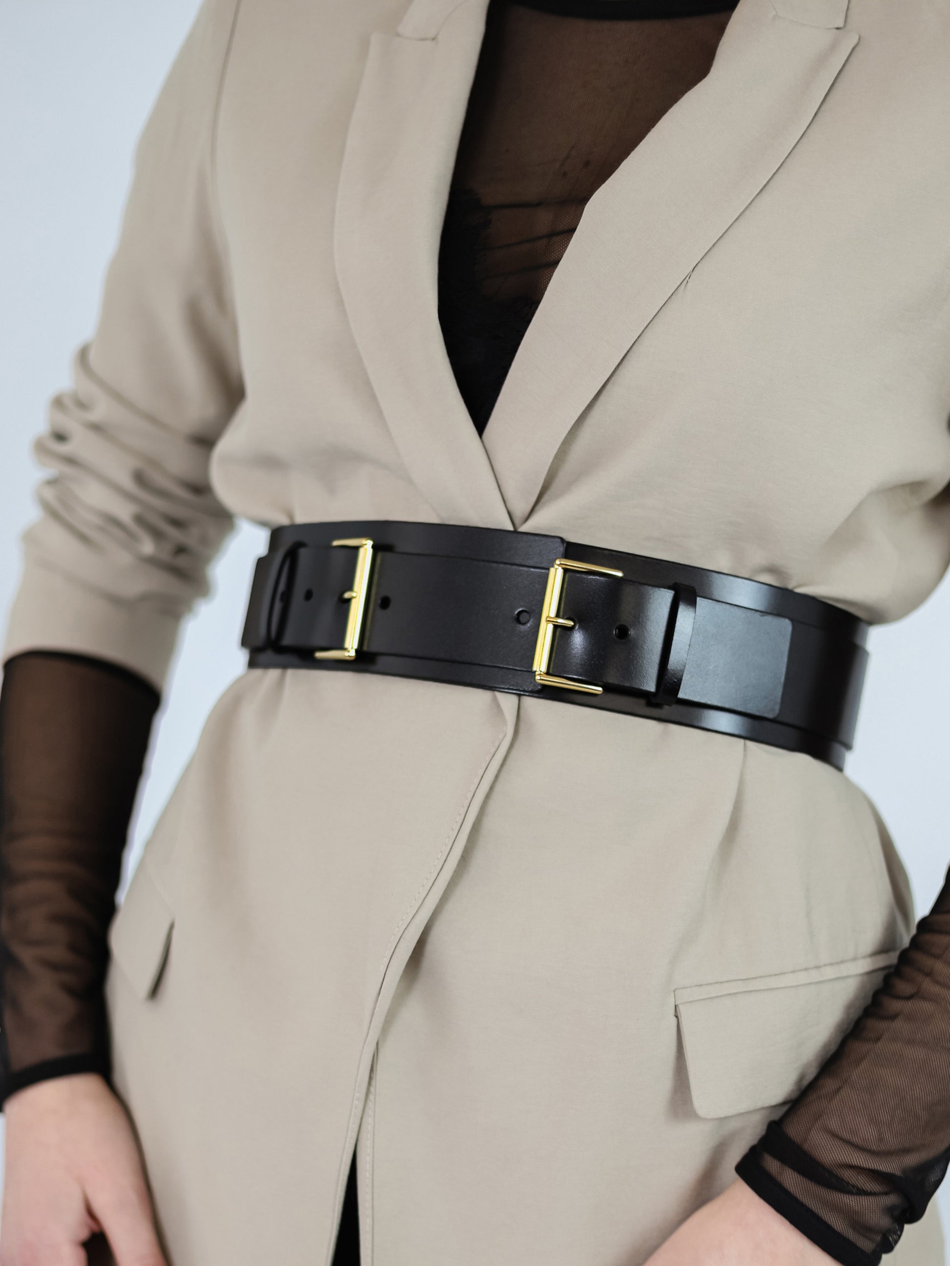 Front detailed view of black leather belt. 