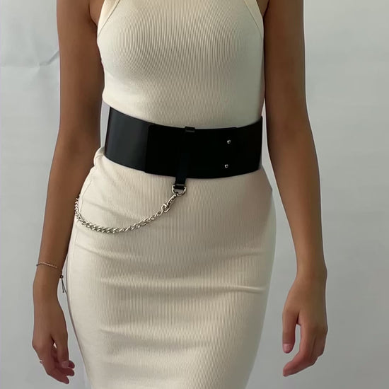 Video presenting the wide leather belt worn over white dress.