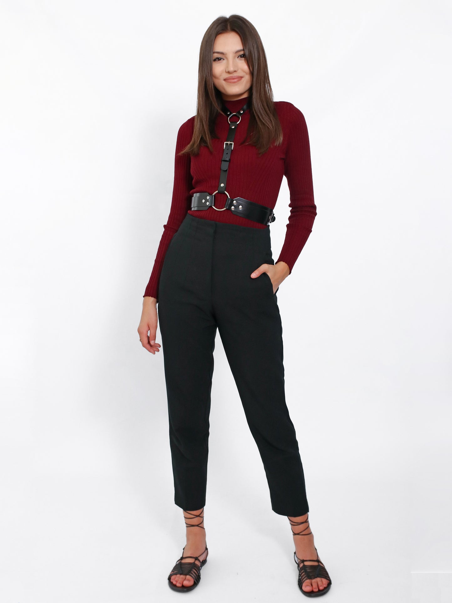 Complet look with leather harness, black pants and burgundy blouse
