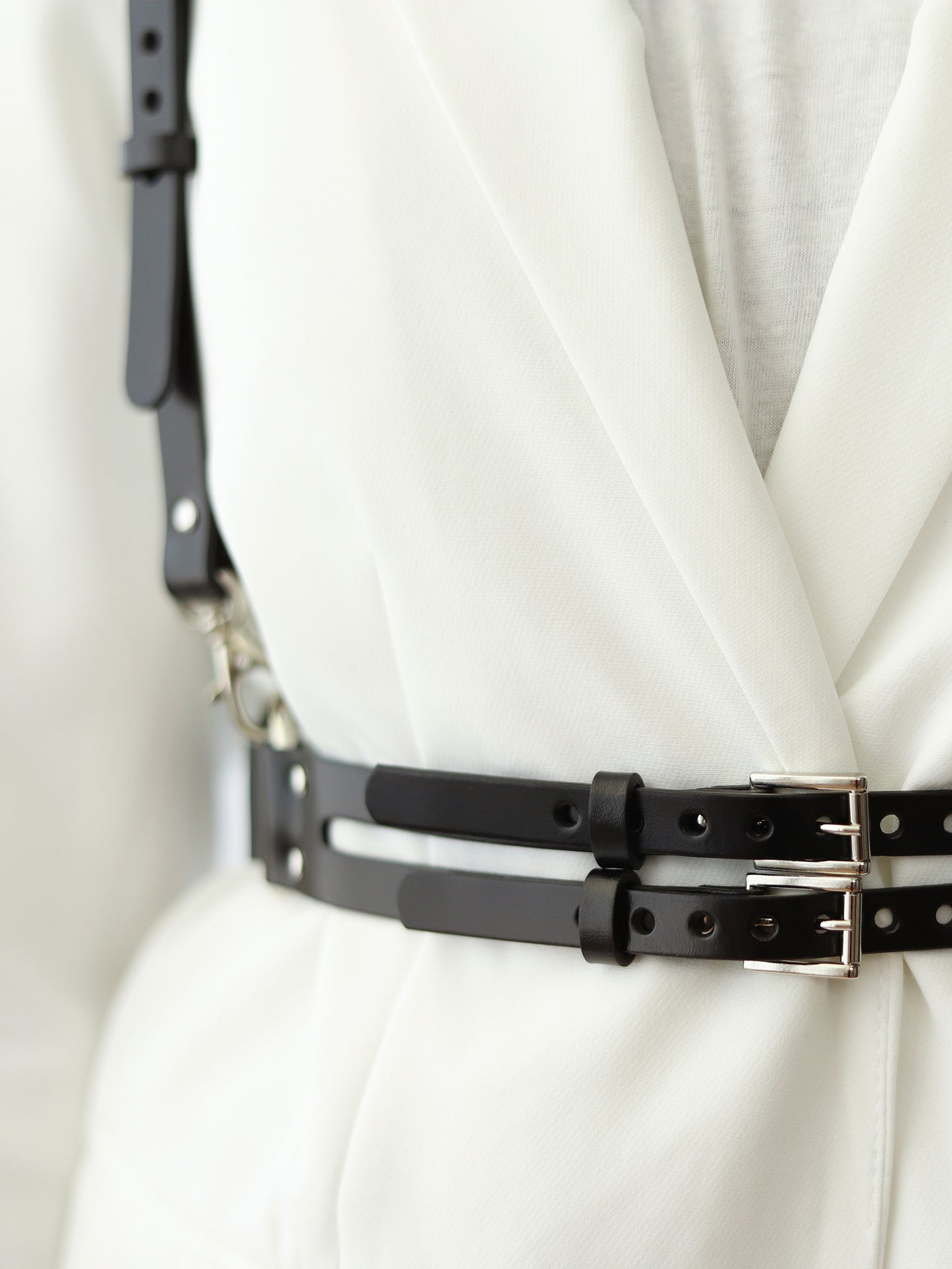 Detailed view of black leather harness.
