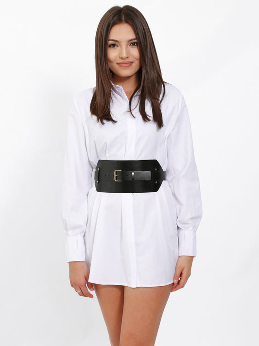 Black wide leather belt worn over shirt dress.