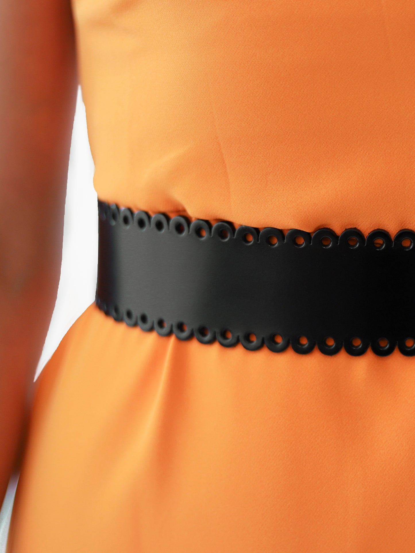 Close view of scalloped leather belt.