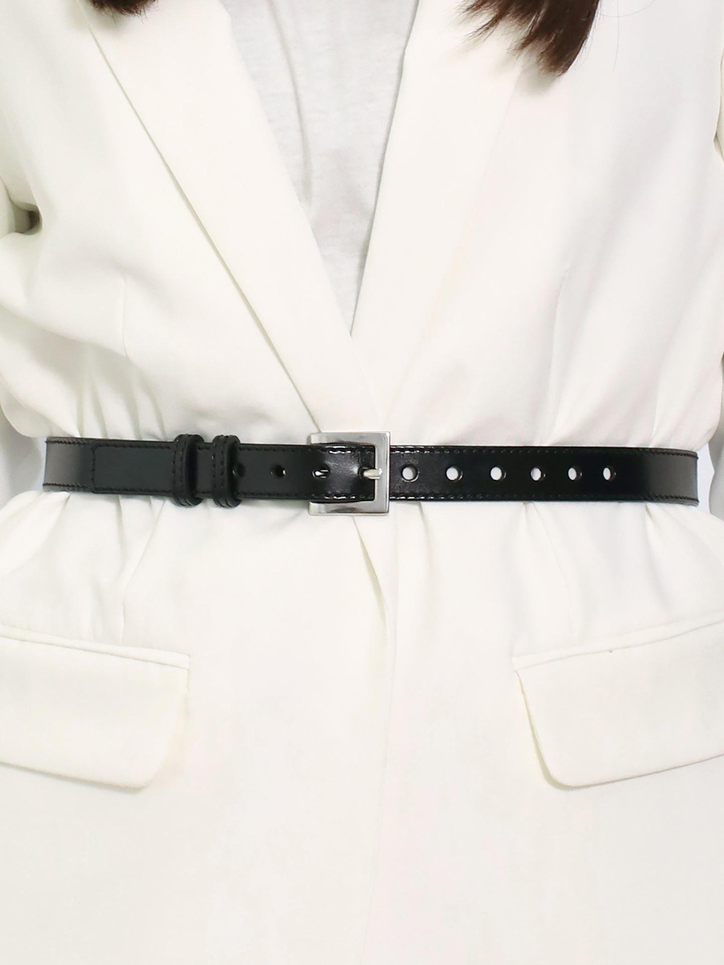 Detailed view of slim leather belt.