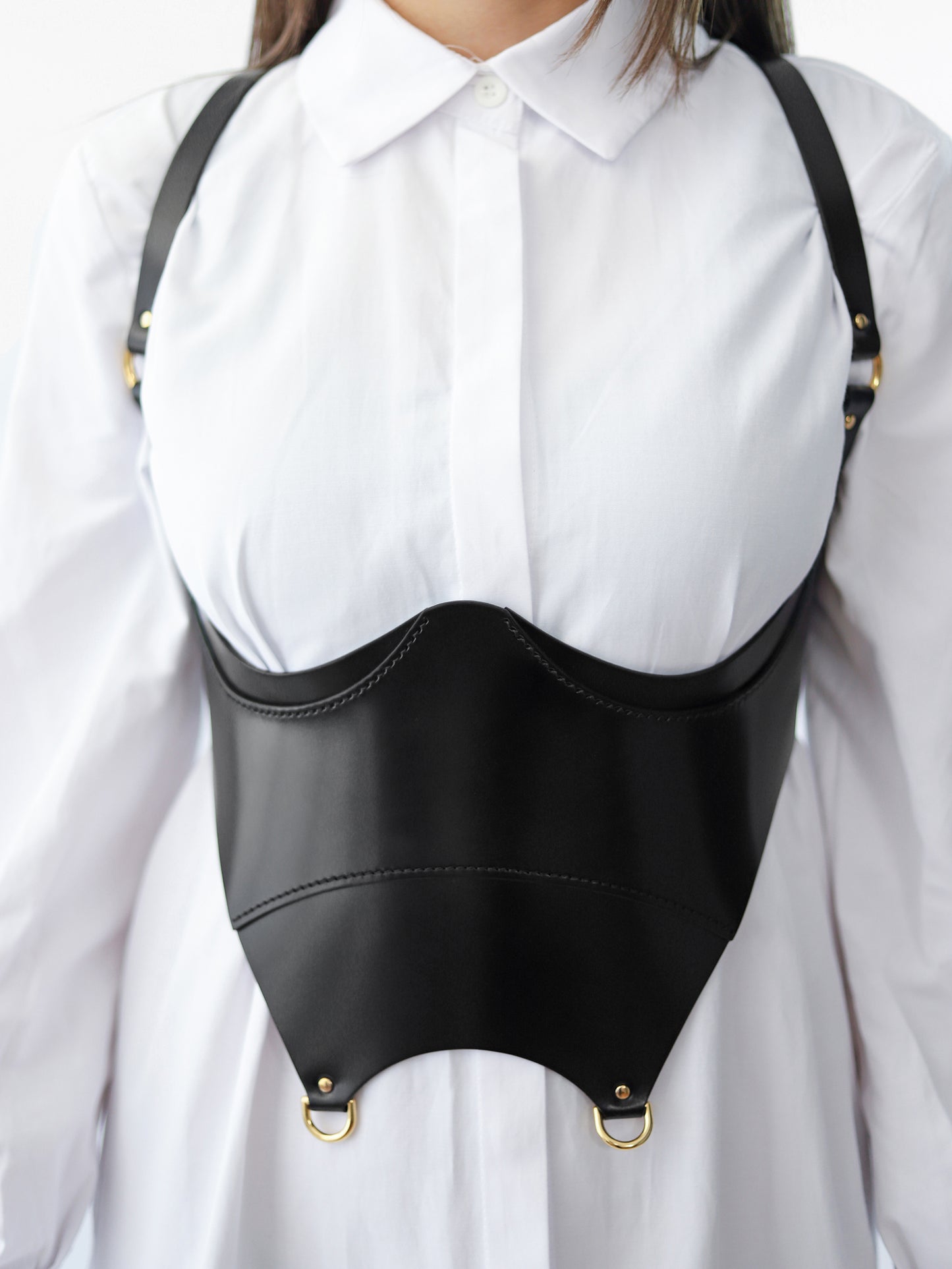 Detailed view of black underbust corset harness.