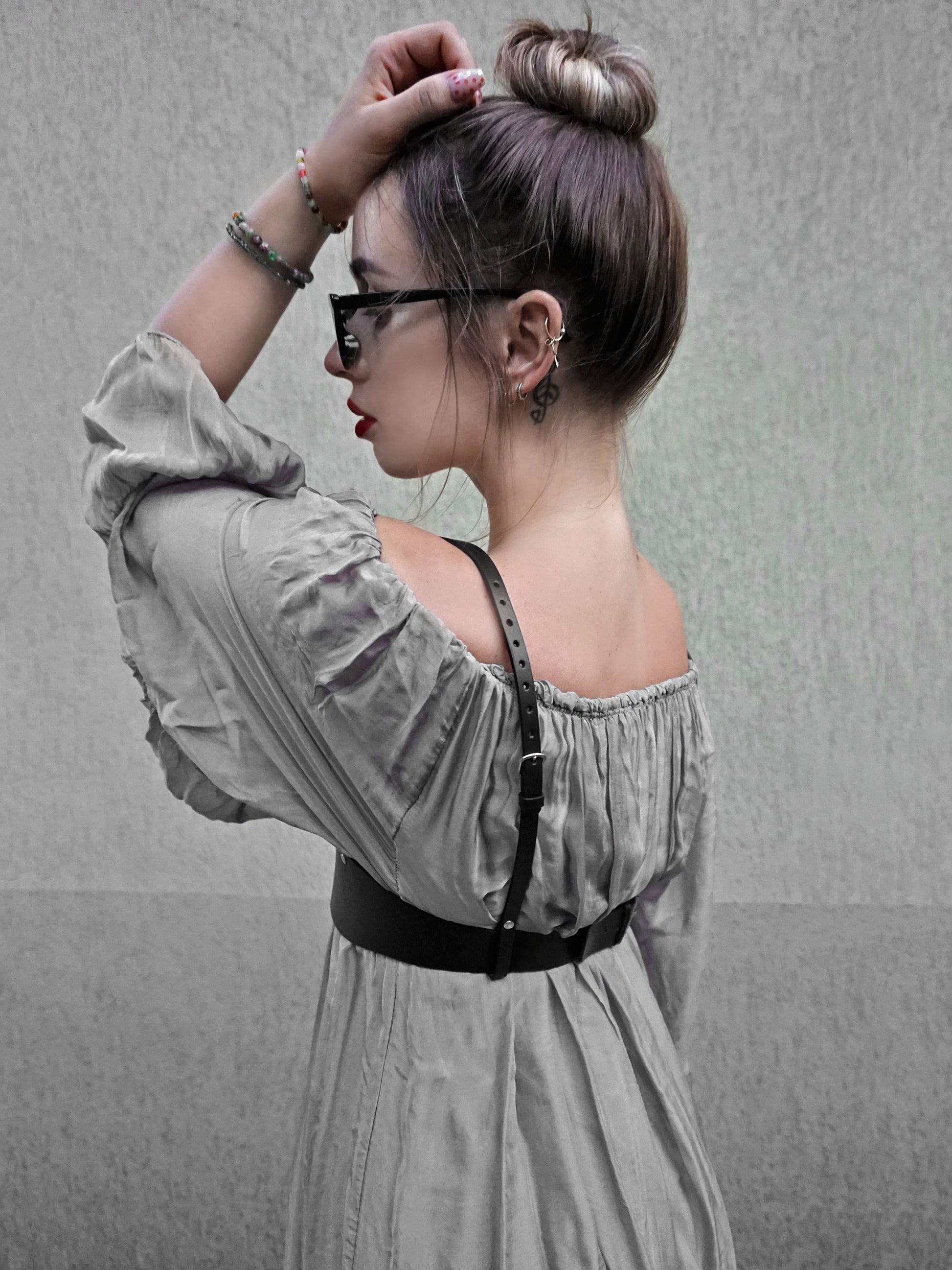 Side view of black leather underbust harness.