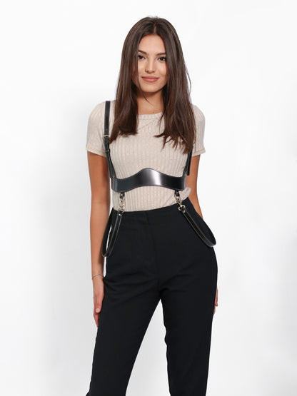 Underbust leather harness worn over beige t-shirt.